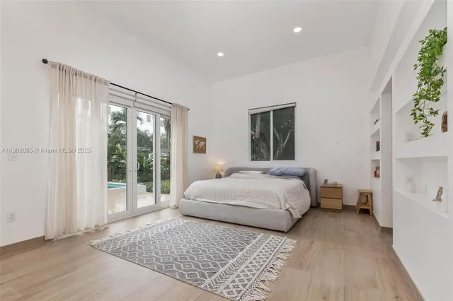 a bedroom with a large bed and a large window