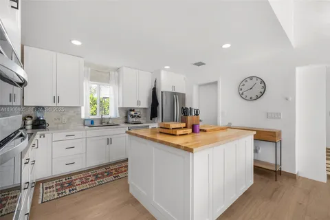 a kitchen with stainless steel appliances granite countertop a sink and a stove