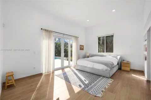 a bedroom with a large bed and a large window