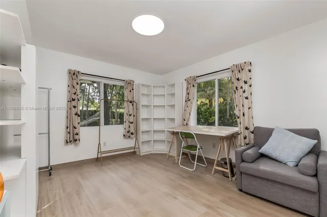 a living room with furniture a window and table
