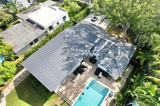 an aerial view of a house with a yard