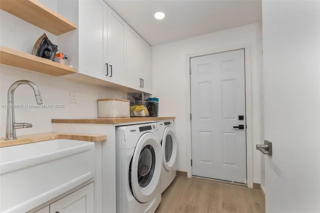 a utility room with sink dryer and washer