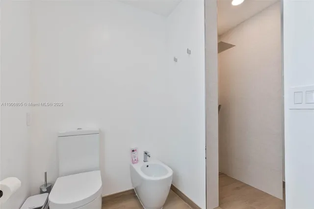 a white toilet sitting next to a bathroom sink
