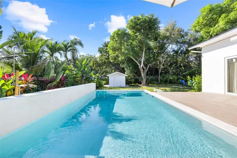 a view of swimming pool with a yard
