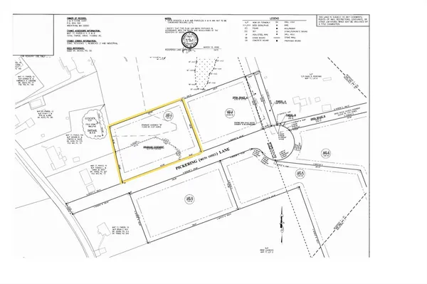 a view of a yard with plants and a building