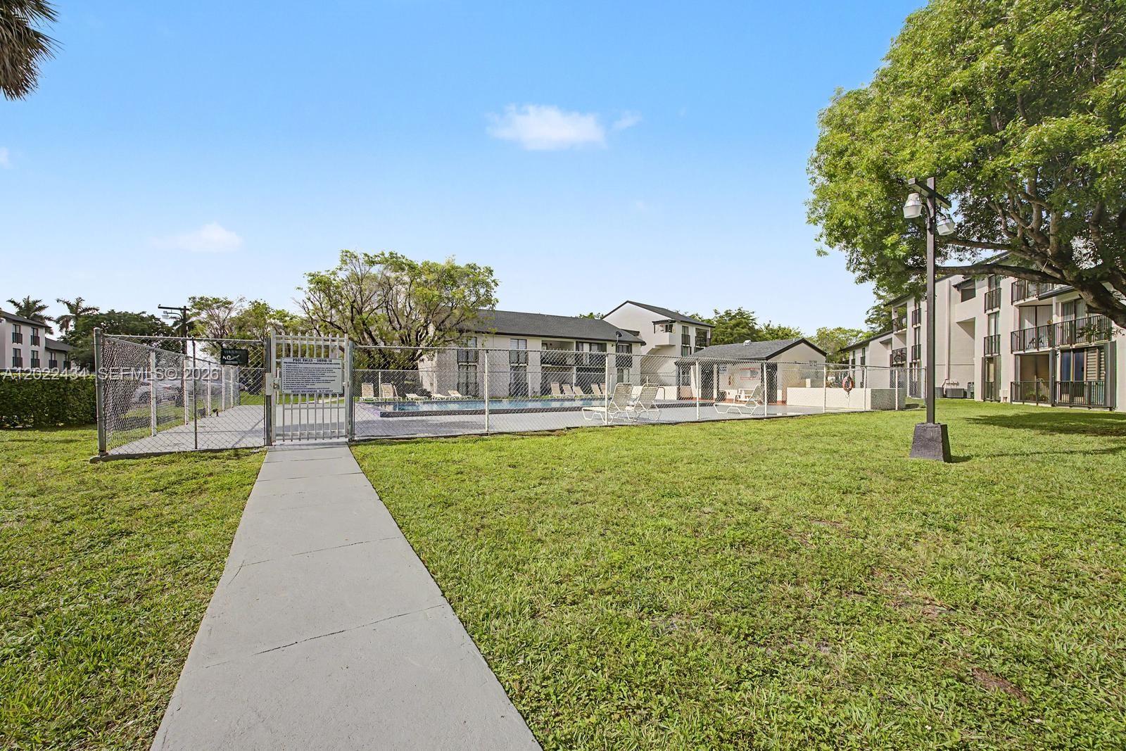 13045 Southwest 68th Street, Unit 111 Miami, FL 33183 - Photo 15 of 15 a view of a house with a yard