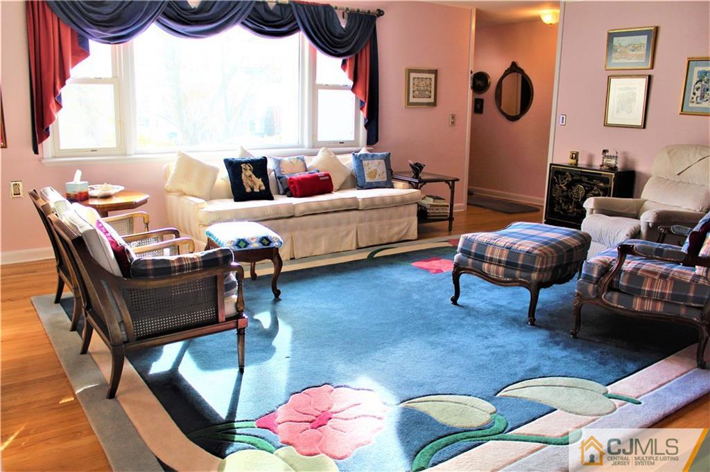 23 Clive Hills Road Edison, NJ 08820 - Photo 11 of 25 a living room with furniture and a large window
