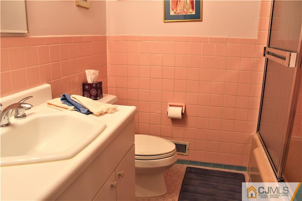 23 Clive Hills Road Edison, NJ 08820 - Photo 16 of 25 a bathroom with a sink and a toilet