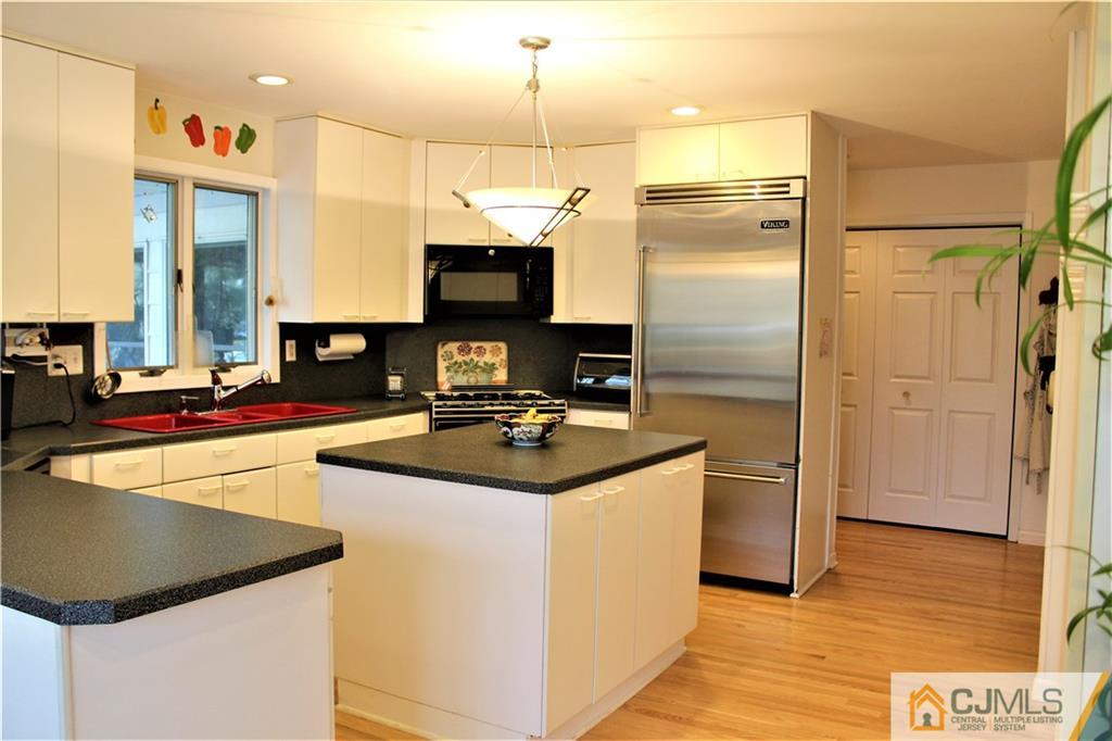23 Clive Hills Road Edison, NJ 08820 - Photo 3 of 25 a kitchen with stainless steel appliances a stove refrigerator and microwave