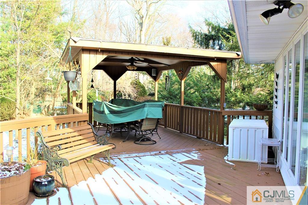 23 Clive Hills Road Edison, NJ 08820 - Photo 7 of 25 a view of balcony with wooden floor and outdoor seating