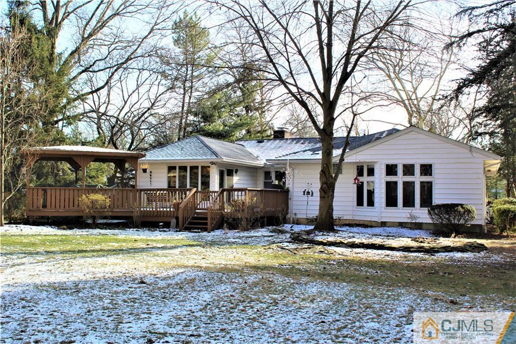 23 Clive Hills Road Edison, NJ 08820 - Photo 8 of 25 a front view of a house with a yard yard and a large tree