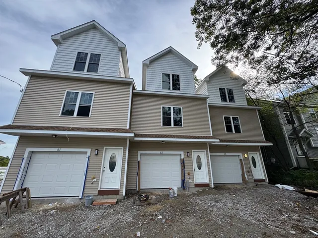 a view of a house with a yard and garage