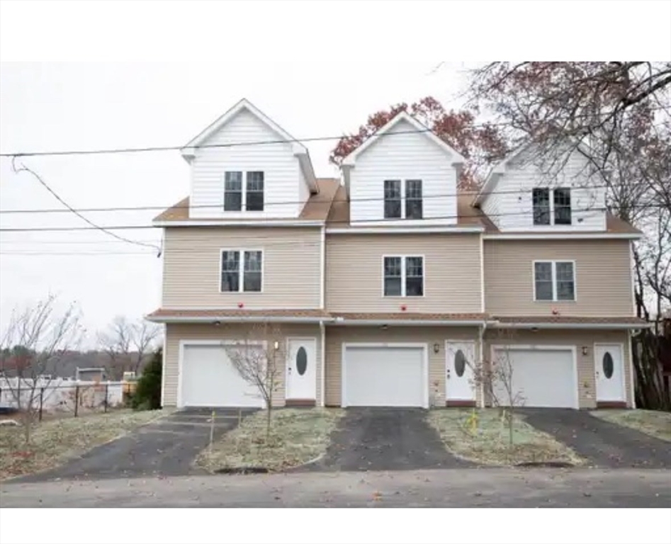 63 Progressive Street Worcester, MA 01604 - Photo 1 of 22 a front view of a house with a yard