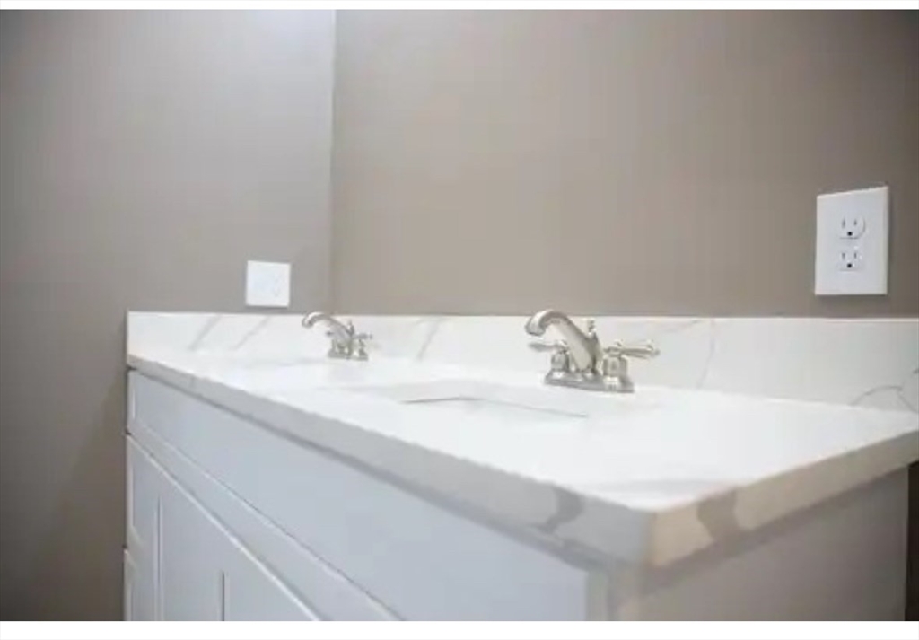 63 Progressive Street Worcester, MA 01604 - Photo 11 of 22 a bathroom with a sink and a mirror