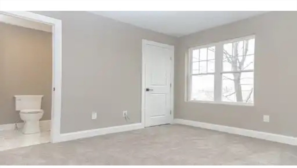 63 Progressive Street Worcester, MA 01604 - Photo 12 of 22 a view of an empty room with a window