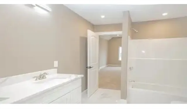 a bathroom with a granite countertop sink a mirror and a vanity