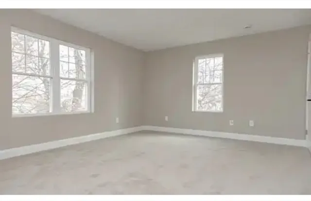 a bathroom with a granite countertop sink a shower and a mirror