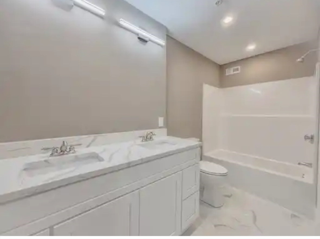 63 Progressive Street Worcester, MA 01604 - Photo 19 of 22 a bathroom with a sink toilet and shower