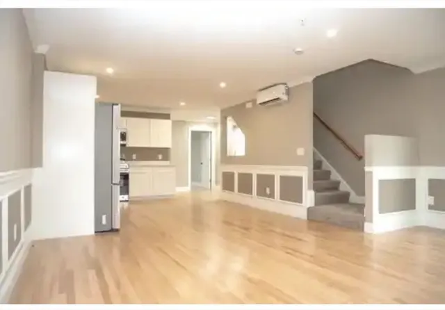 a view of a kitchen with a sink and refrigerator