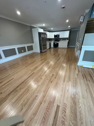 a view of a room with wooden floor