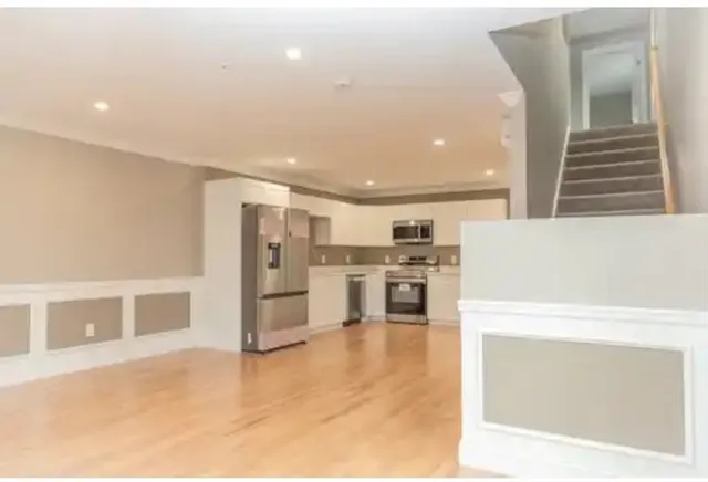 a view of kitchen with furniture and refrigerator