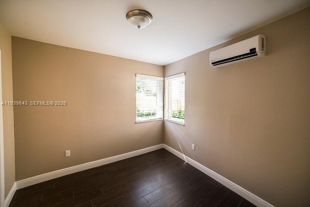 500 Southwest 9th Avenue, Unit 8 Miami, FL 33130 - Photo 4 of 10 an empty room with wooden floor and windows
