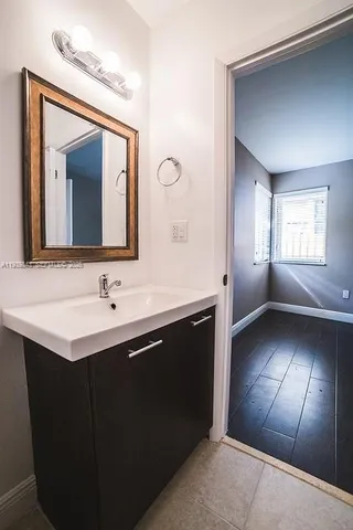 a bathroom with a double vanity sink and a mirror