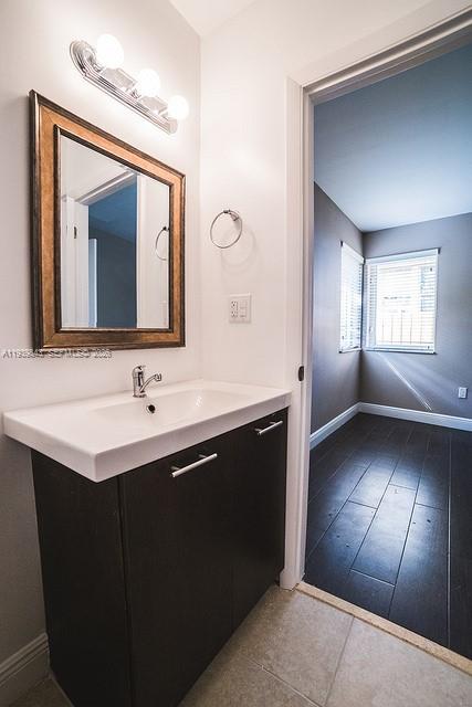 500 Southwest 9th Avenue, Unit 8 Miami, FL 33130 - Photo 5 of 10 a bathroom with a double vanity sink and a mirror