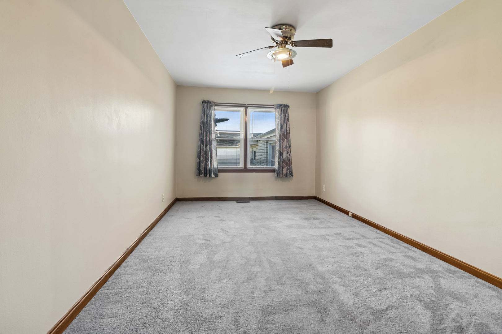 3030 South Berta Road Braceville, IL 60407 - Photo 16 of 24 an empty room with windows and ceiling fan
