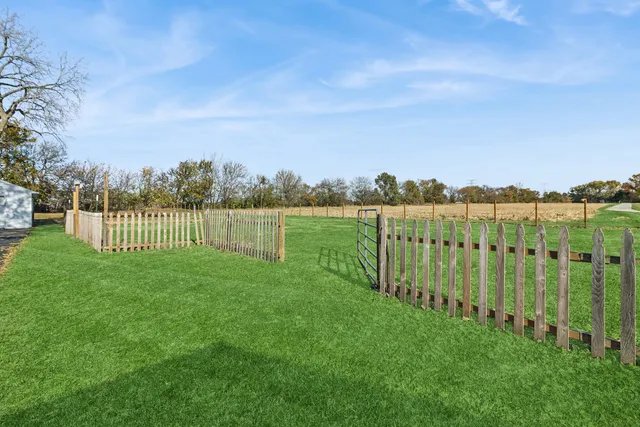 a aerial view of a house with a yard and lake view
