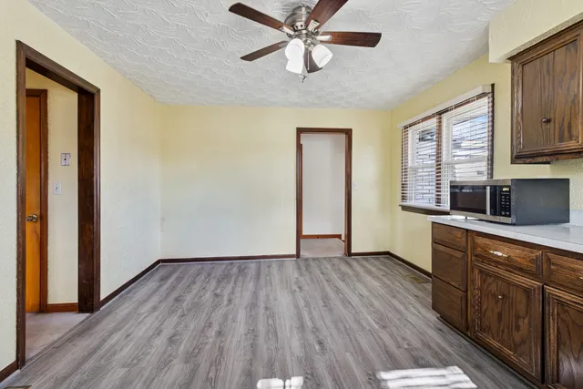 a kitchen with wooden floors and a sink