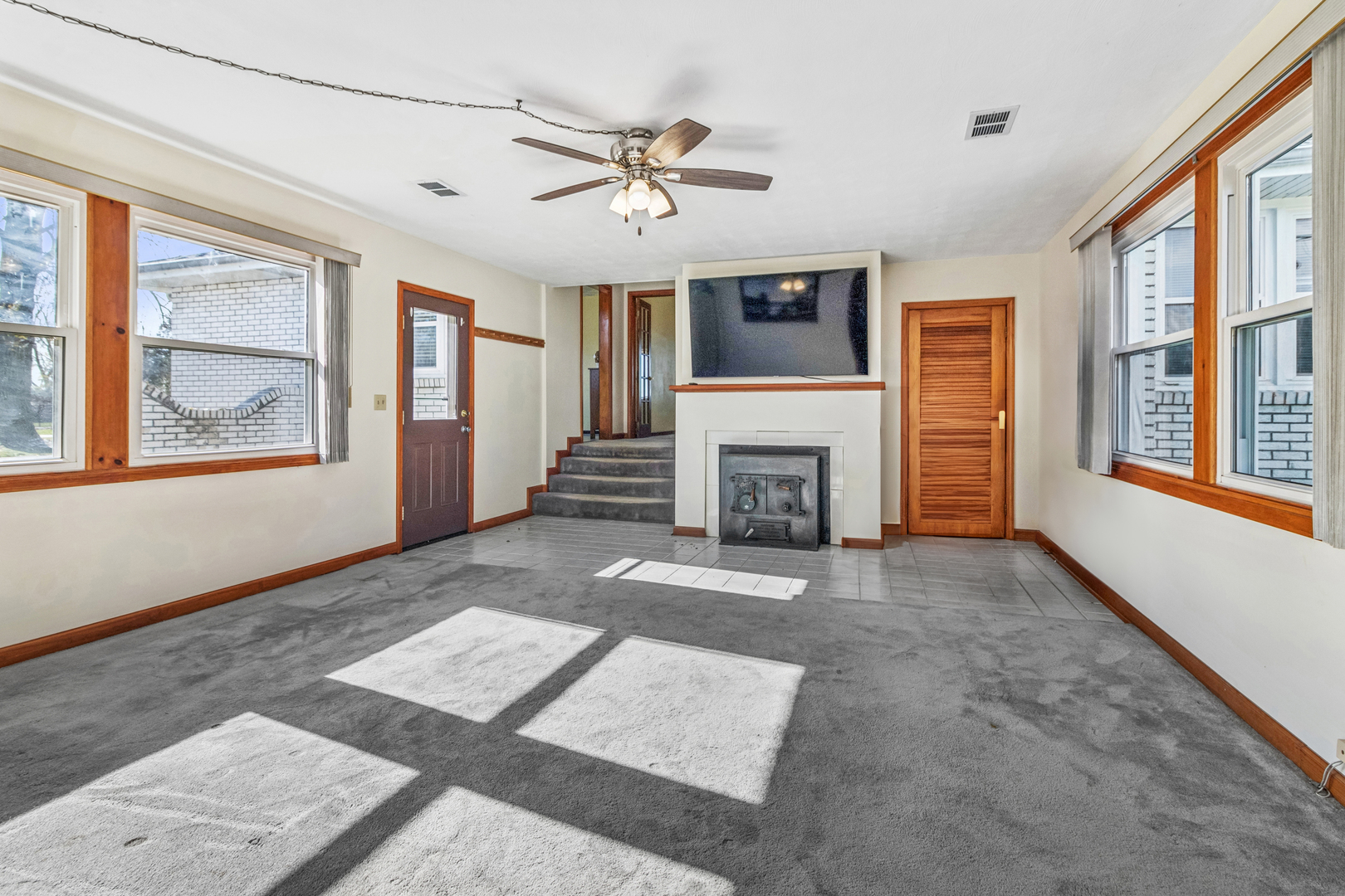 3030 South Berta Road Braceville, IL 60407 - Photo 10 of 24 a view of an empty room with a fireplace and a window