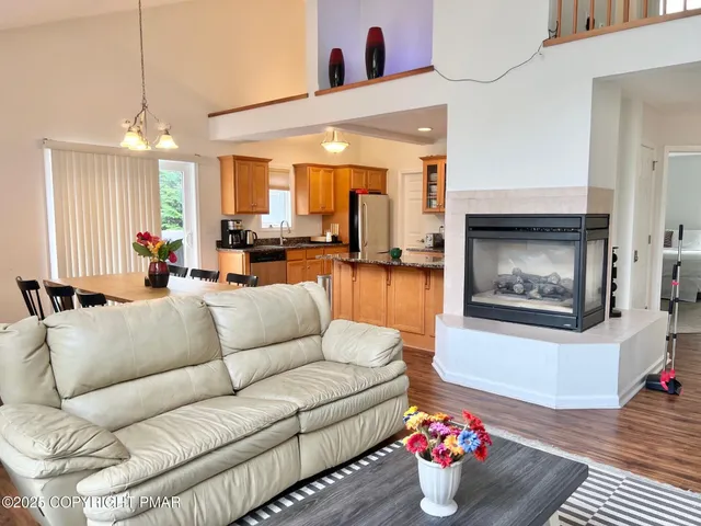 a living room with furniture and a chandelier