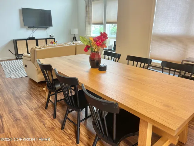 a view of a dining room with furniture and wooden floor