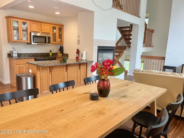 a kitchen with a dining table chairs and kitchen view