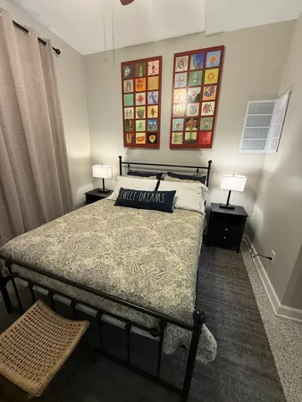 a bedroom with a bed and a window