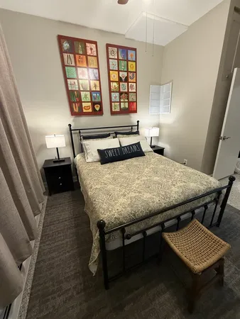 a bedroom with a bed and a window