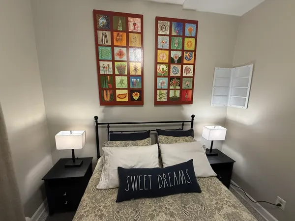 a bedroom with a bed and a window