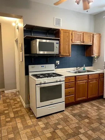 a kitchen with a stove a sink and a microwave