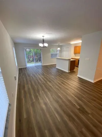 a view of a room with wooden floor