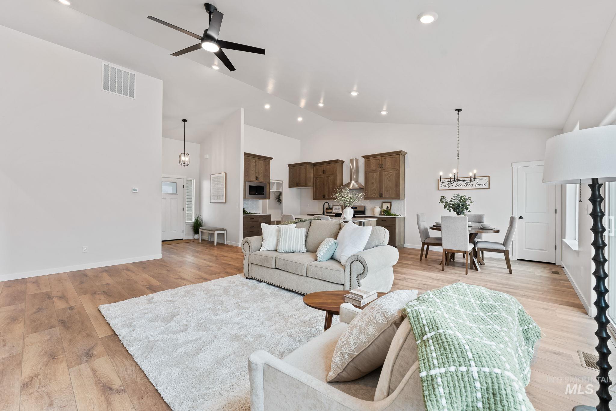 2220 Great Basin Way Burley, ID 83318 - Photo 11 of 39 Living area with light wood-style flooring, ceiling fan, vaulted ceiling, and hanging lights