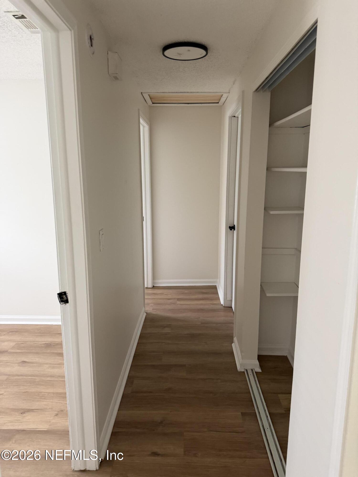 7539 Walden Road Jacksonville, FL 32244 - Photo 15 of 18 a view of a hallway with wooden floor