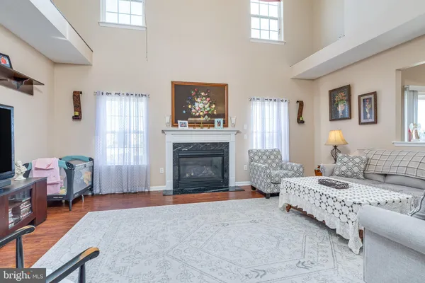 a work room with furniture a rug and a fireplace