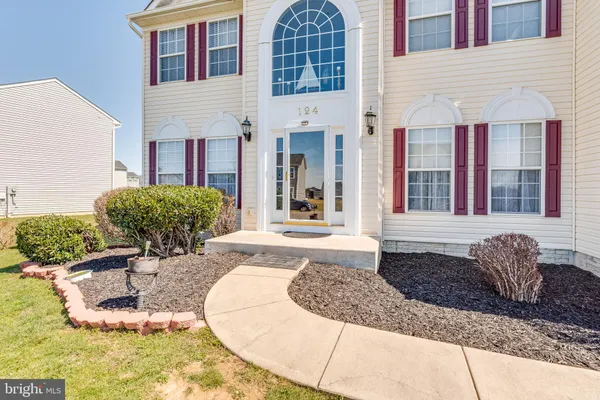 a view of an entryway with wooden floor and stairs