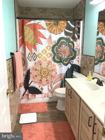 a bathroom with a toilet a sink and a mirror
