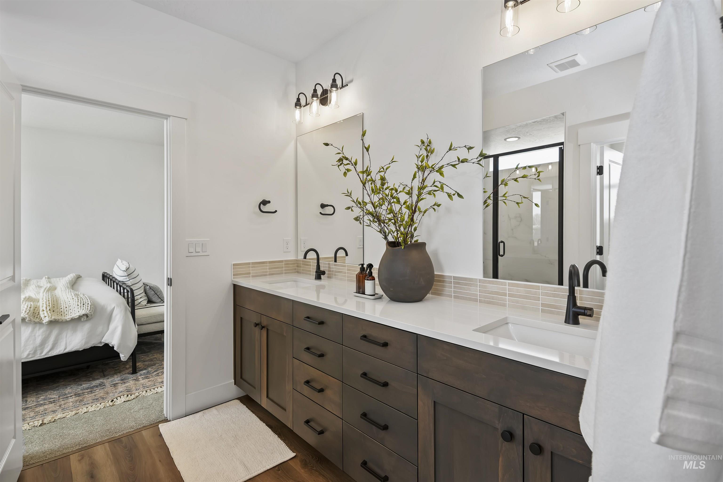 749 South Calhoun Lane Star, ID 83669 - Photo 23 of 34 Full bathroom with double vanity, a marble finish shower, ensuite bath, and dark wood-type flooring