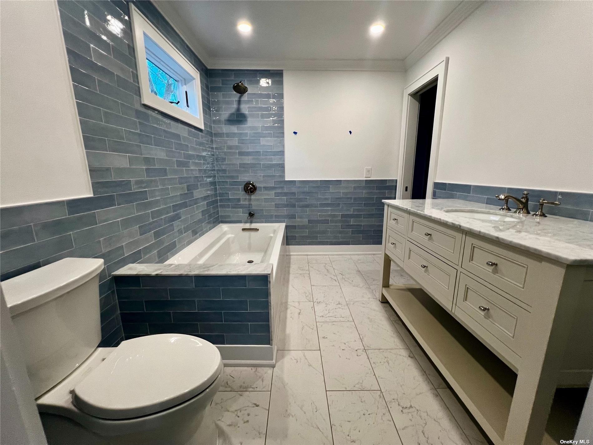 23 A Oakhurst Road Hampton Bays, NY 11946 - Photo 12 of 16 a bathroom with a sink a toilet and mirror
