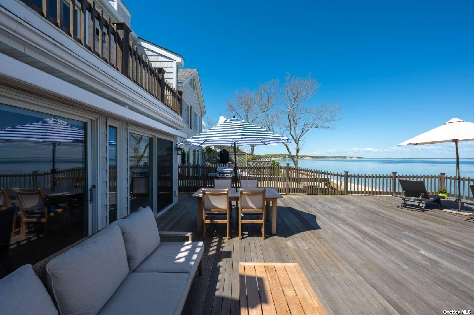 23 A Oakhurst Road Hampton Bays, NY 11946 - Photo 6 of 16 a view of a patio with dining table and chairs with wooden floor