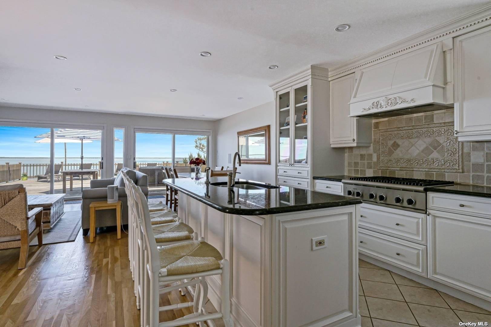 23 A Oakhurst Road Hampton Bays, NY 11946 - Photo 7 of 16 a view of a kitchen with stainless steel appliances granite countertop a stove and a sink