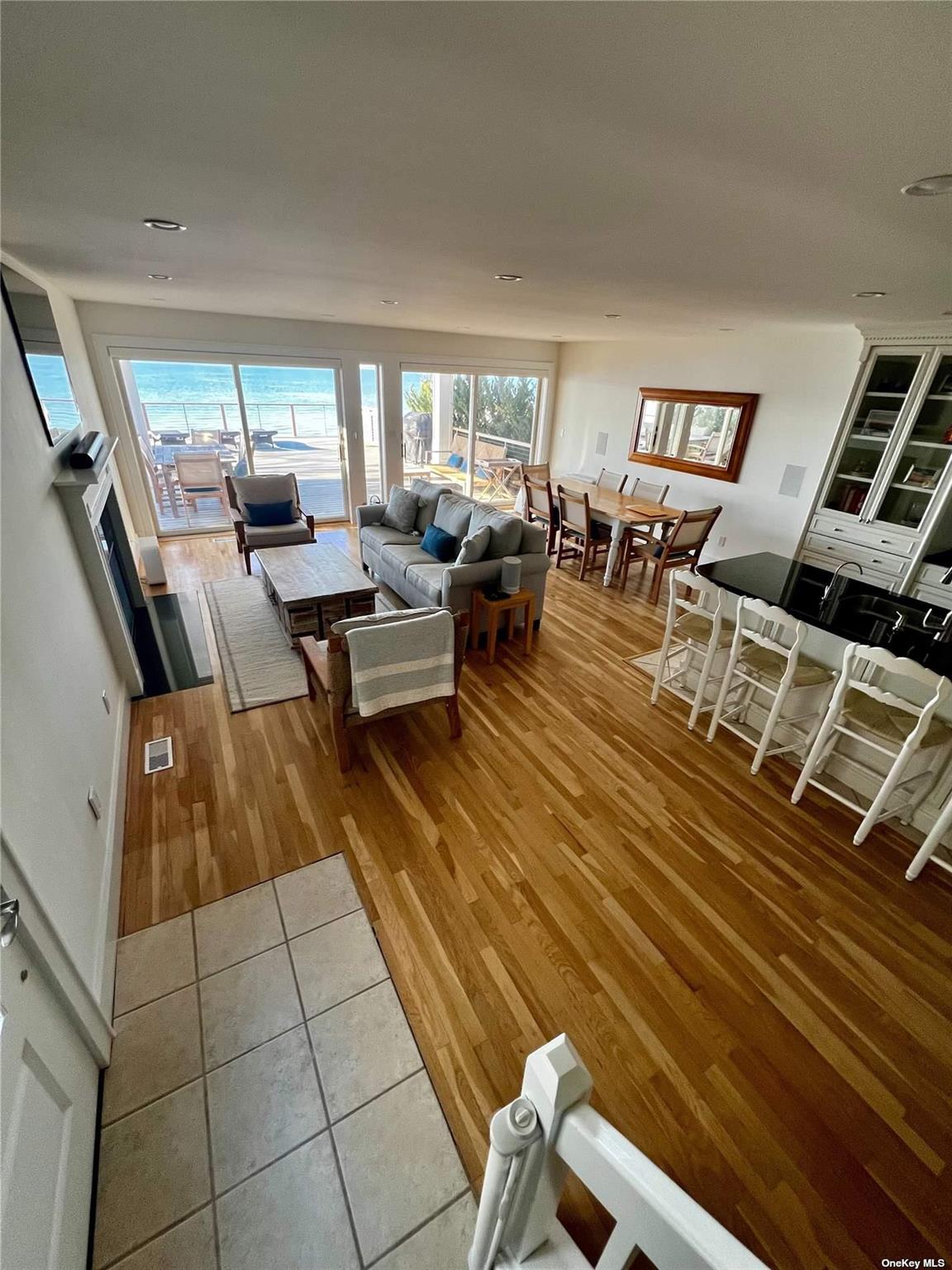 23 A Oakhurst Road Hampton Bays, NY 11946 - Photo 8 of 16 a living room with lots of furniture and a rug